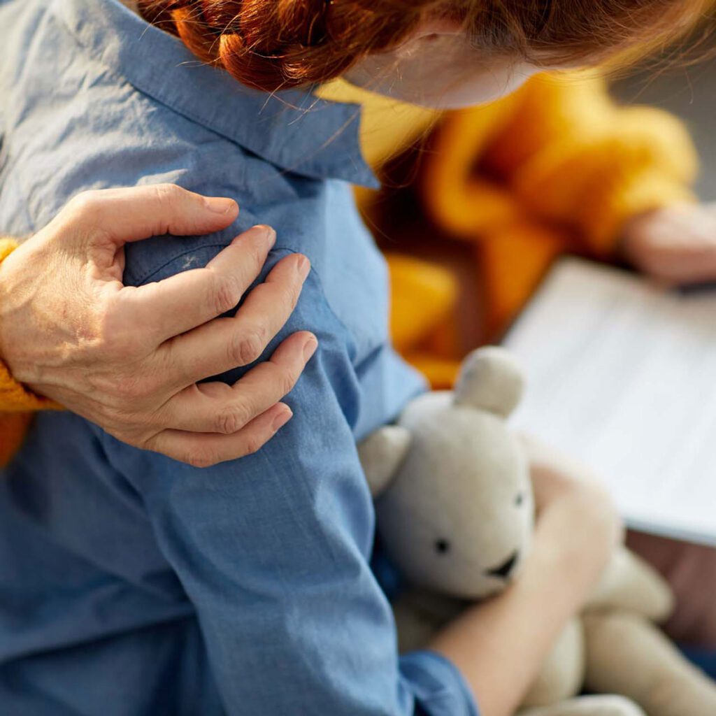 Jigsaw Adoption | Child with comforting hand on shoulder